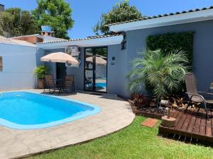 a swimming pool in the backyard of a house at Pousada Selenita in Ametista do Sul