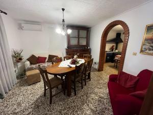 a dining room and living room with a table and chairs at Corte Galassi in Torsa