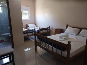 a room with two beds and a couch in it at Hotel e Restaurante Rota do Pampa in Estância Teixeira