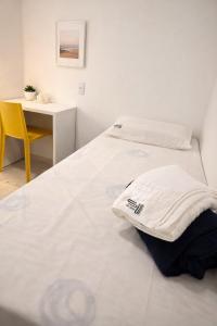 two beds in a room with a table and a chair at Sun Smart Hotel in Recife +41 photos