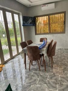 a dining room with a table and chairs at villa lina in Aït Mazou
