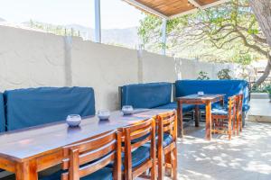 a table and chairs with bowls on top at Vito Hotel Boutique Taganga in Taganga