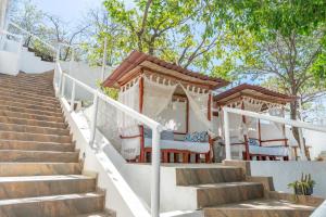 a set of stairs with a table and chairs at Vito Hotel Boutique Taganga in Taganga