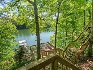 a wooden deck with benches next to a lake at Smith Lake Retreat - Close To Trident Marina in Crane Hill