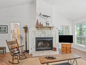 a living room with a fireplace and a tv at Smith Lake Retreat - Close To Trident Marina in Crane Hill