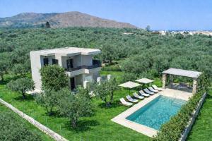 a villa with a swimming pool and a resort at Luxury Villa Marian with Private Pool and Jacuzzi near the Beach of Georgioupoli in Georgioupolis