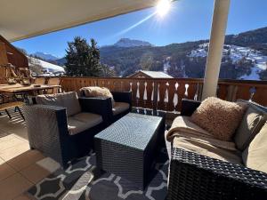 a balcony with chairs and a table and a view at Chalet apartment & mountain view in Saas