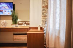 a room with a mirror and a bed in a room at NOMA Boutique Hotel in Shkodër +140 photos