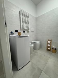 a bathroom with a white sink and a toilet at Salix Aurea in San Martino Siccomario +22 photos