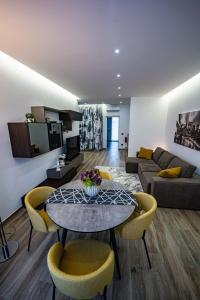 a living room with a table and chairs and a couch at Residenza La Chiave in Mantova +21 photos