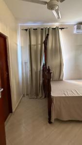 a bedroom with a bed with a canopy and curtains at Noorhaven stay in Watamu