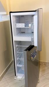a refrigerator with its door open in a room at Noorhaven stay in Watamu