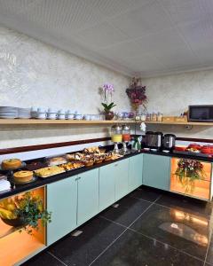 a kitchen with a lot of food on the counters at Bandeirantes Hotel in Cuiabá