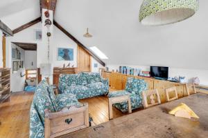 a living room with two chairs and a couch at La Grangia - mountain loft in Rollieres