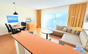 a living room with a couch and a table at Boddenhof Apartment 48 - Terrasse für Hundefreunde in Buschvitz