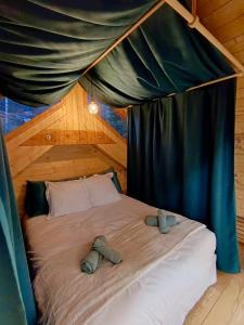 a bedroom with a bed in a tent at Hôtel La bonne hôtesse in Chambon-sur-Lac