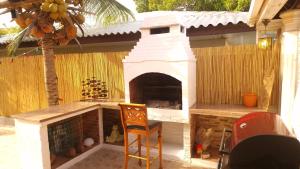 a outdoor fireplace with a chair in front of it at Reverie in Willemstad