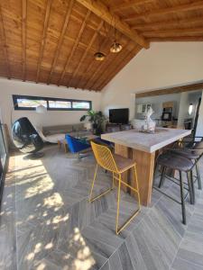 a living room with a large wooden table and chairs at Maison familiale in Le Teich
