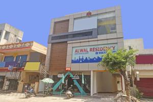 a building with a sign on the side of it at OYO 93463 Alwal Residency in Hyderabad +23 photos