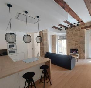 a kitchen and living room with a couch and a table at Casa riera in Valderrobres
