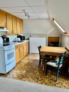 a kitchen with a wooden table and a table and chairs at Hilltop Landing in Digby