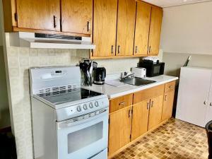 a kitchen with white appliances and wooden cabinets at Hilltop Landing in Digby