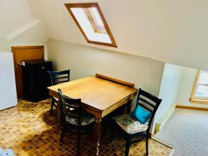 a dining room with a wooden table and chairs at Hilltop Landing in Digby