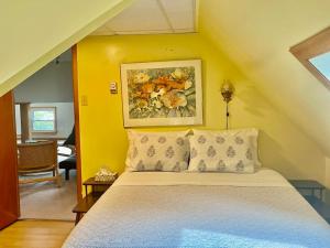 a bedroom with a bed and a painting on the wall at Hilltop Landing in Digby