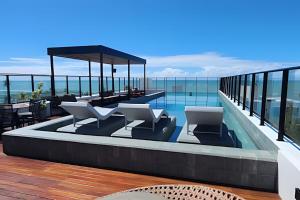 a swimming pool on the roof of a building at Flat a 20 metros da praia in João Pessoa