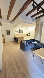 a living room with a blue couch and a table at Casa riera in Valderrobres