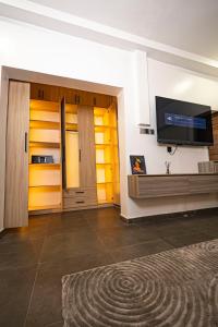 a living room with a flat screen tv on a wall at Ocean View Lekki Ikate in Alaguntan