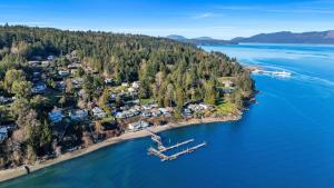 an aerial view of a small island in the water at Beachbreeze Oceanfront 4BR1Den4BA Romantic Sunrise & Celestial Views in Mill Bay