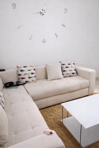 a white living room with a white couch at Diamonds in Rabat +2 photos