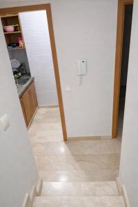 a hallway with a white door and a tile floor at Diamonds in Rabat
