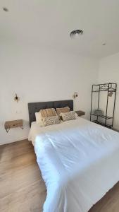 a large white bed in a white bedroom at Casa riera in Valderrobres