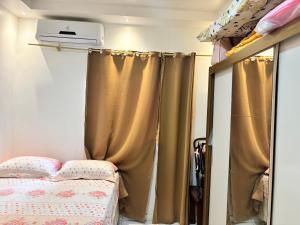 a bedroom with a bed and curtains in it at Casa chácara para alugar no período do festival de Parintins in Parintins +12 photos