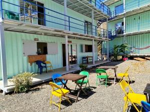 a patio with colorful chairs and tables in a building at Hotel Marea in San Juan del Sur