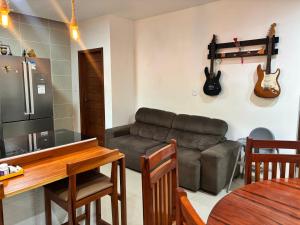 a living room with a couch and a table at Casa chácara para alugar no período do festival de Parintins in Parintins