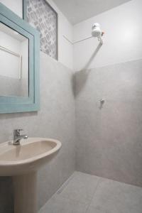 a bathroom with a sink and a mirror and a shower at Mirante Luz Floripa in Florianópolis +42 photos