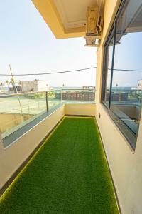 a balcony with green grass on the floor at Ocean View Lekki Ikate in Alaguntan