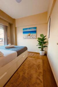 a bedroom with a bed and a potted plant at Blue Horizon Gem On The Port in Rafina