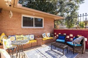 a patio with couches and a table and chairs at Cozy Room with a Pool in Houston