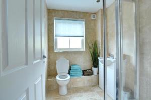 a bathroom with a toilet and a window at 5 Bed in Amroth oc-pw9067 in Amroth +24 photos