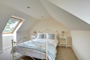 a bedroom with a bed and a window at 5 Bed in Amroth oc-pw9067 in Amroth