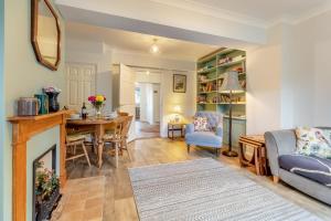 a living room with a fireplace and a table at 3 Bed in Theberton oc-1pcs in Theberton