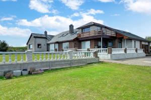 a large house with a fence in front of it at 4 Bed in Moelfre oc-wai202 in Moelfre