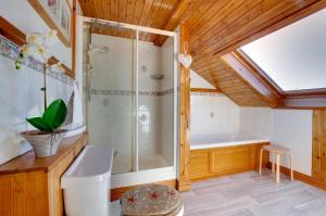 a bathroom with a shower and a bath tub at 4 Bed in Moelfre oc-wai202 in Moelfre +15 photos