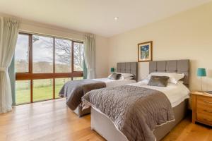 two beds in a bedroom with a large window at 2 Bed in Caersws oc-waa322 in Trefeglwys