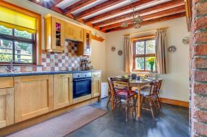 a kitchen with a table and a dining room at 3 Bed in Caernarfon oc-wag443 in Llanwnda +14 photos