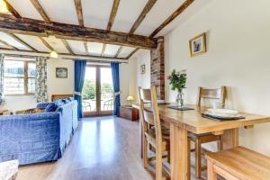 a living room with a table and a blue couch at 1 Bed in Welshpool oc-75714 in Meifod